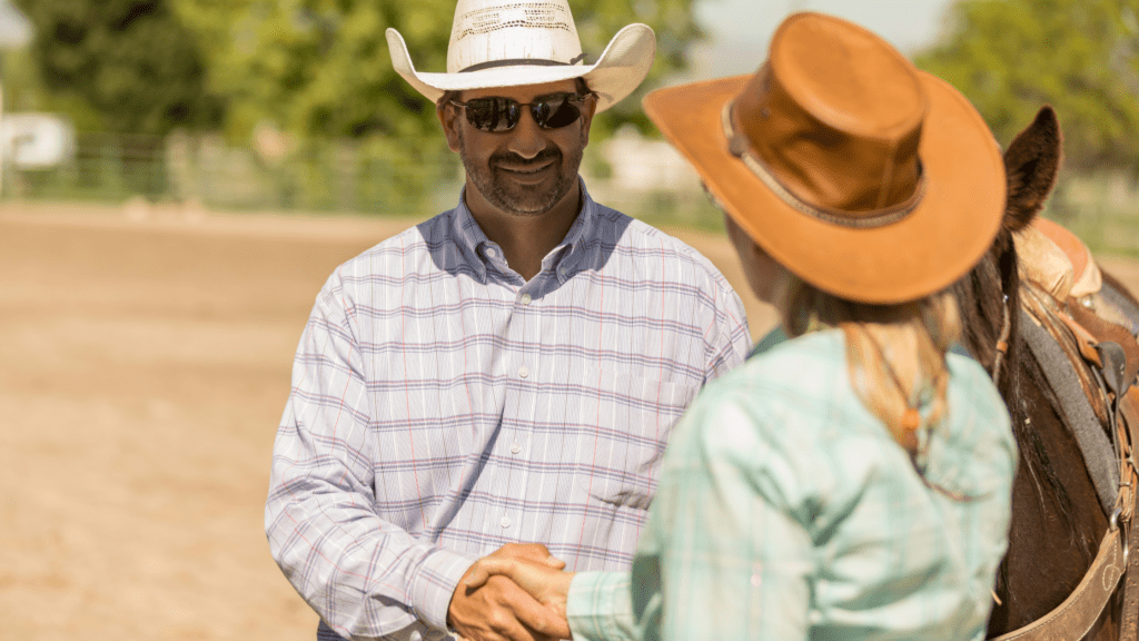 Handshaking Male and Female Ranch Hand 
