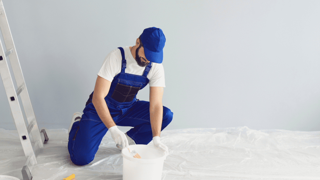 painter gathering paint for painting the inside of a home 