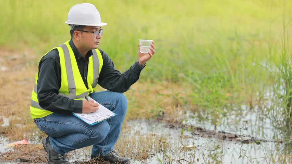 Environmental analyst inspecting water and evaluating strategies for eco-friendly renewable energy