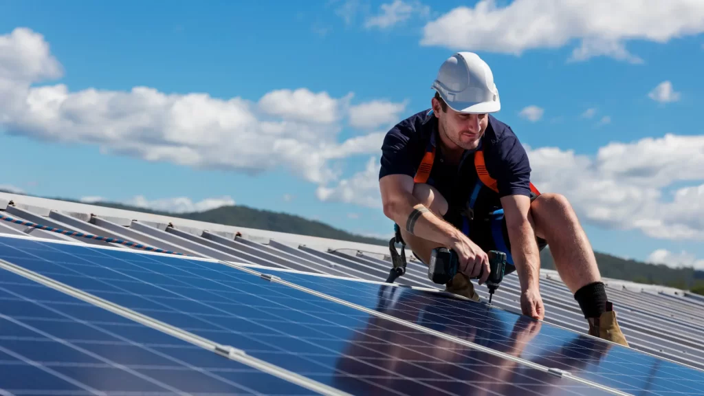 Solar technician installing solar panels for renewable energy
