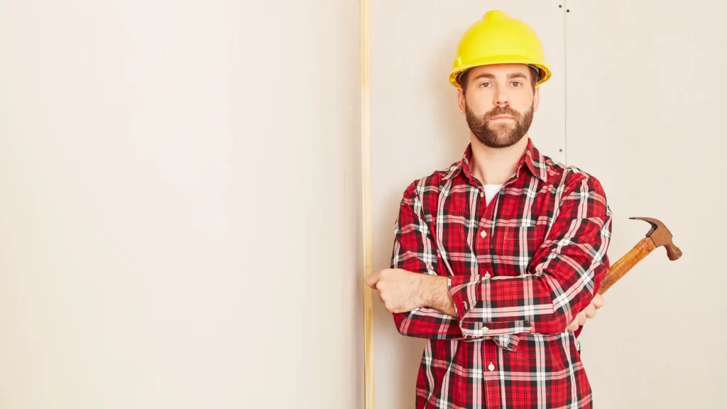 How Much Do Carpenters Make - Carpenter in safety helmet