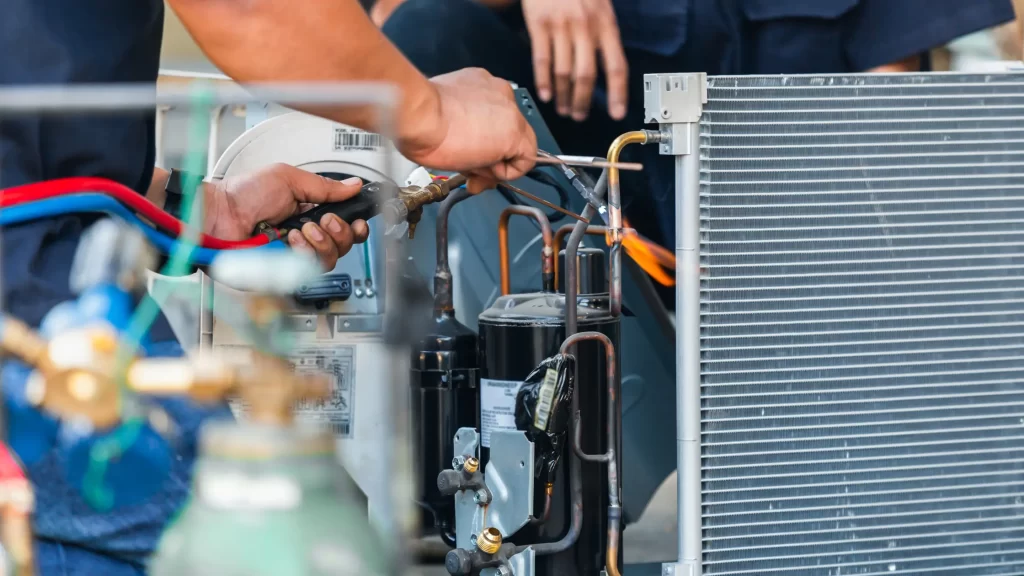 Close-up of air conditioning repair team using fuel gases and oxygen, illustrating HVAC training program options