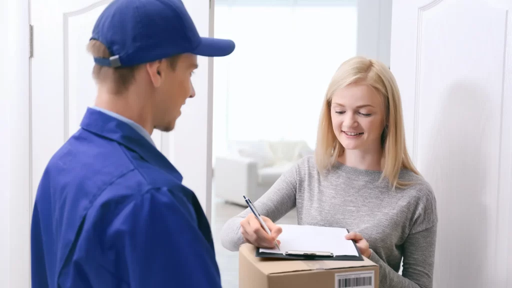 Woman receives package from courier - illustrating considerations for tipping the mailman