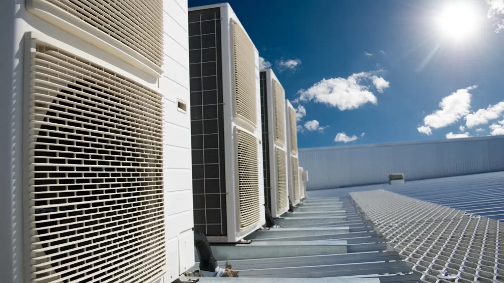 Air conditioner units against a sunny blue sky - representing different types of HVAC systems