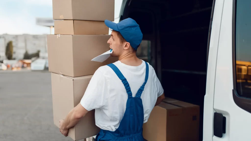 Mailman unloads parcels - illustrating recommended tip amounts for mailmen