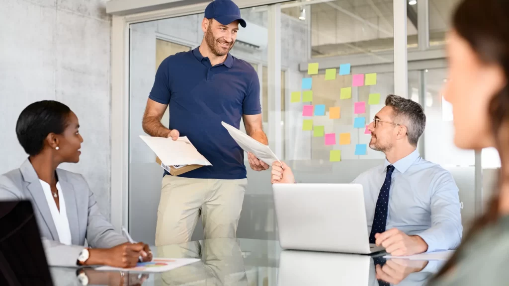 Mailman delivers parcel in modern office - highlighting optimal timing for tipping mailpersons