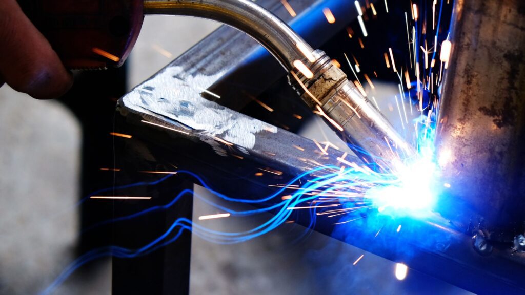 Close-up of welding in progress with sparks flying, demonstrating tips and tricks for mastering welding techniques