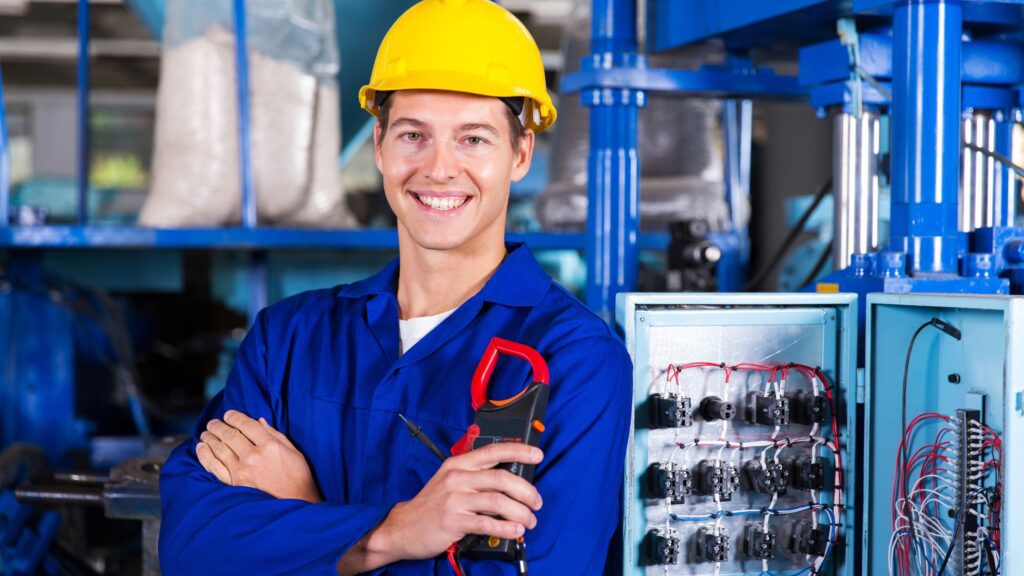 Smiling electrician with tools illustrating how much does an electrician cost