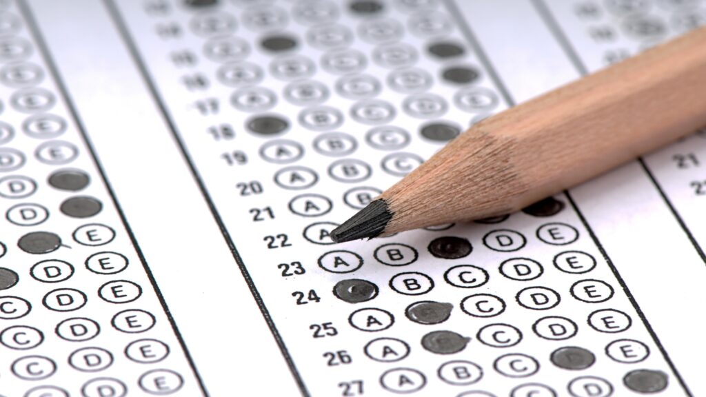 Pencil marking answers on a multiple-choice exam sheet for electrician license