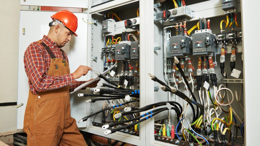 Electrician inspecting electrical panels to address home electrical problems and ensure safety