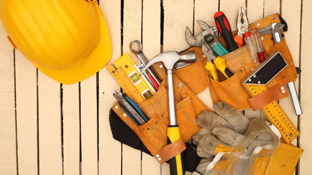 Organized tool belt with hammer, measuring tape, and pliers, showing how to prioritize and customize the best tool belt setup