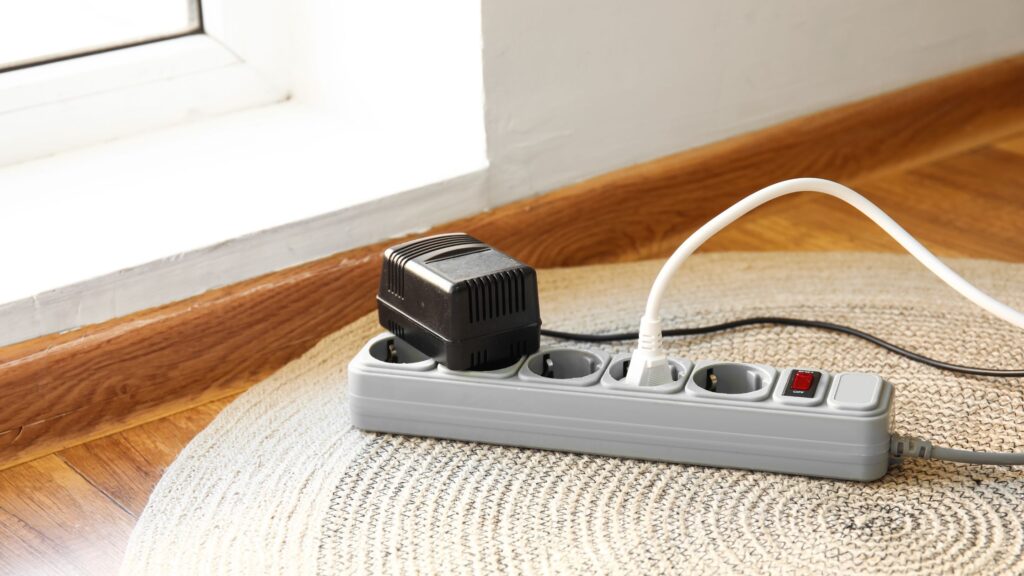 Power strip with multiple devices plugged in, highlighting key factors in choosing the right extension cord for indoor use