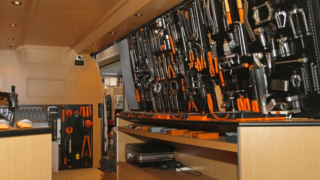 Organized tools on pegboard and shelves, showcasing smart storage solutions in how to build a mobile workshop